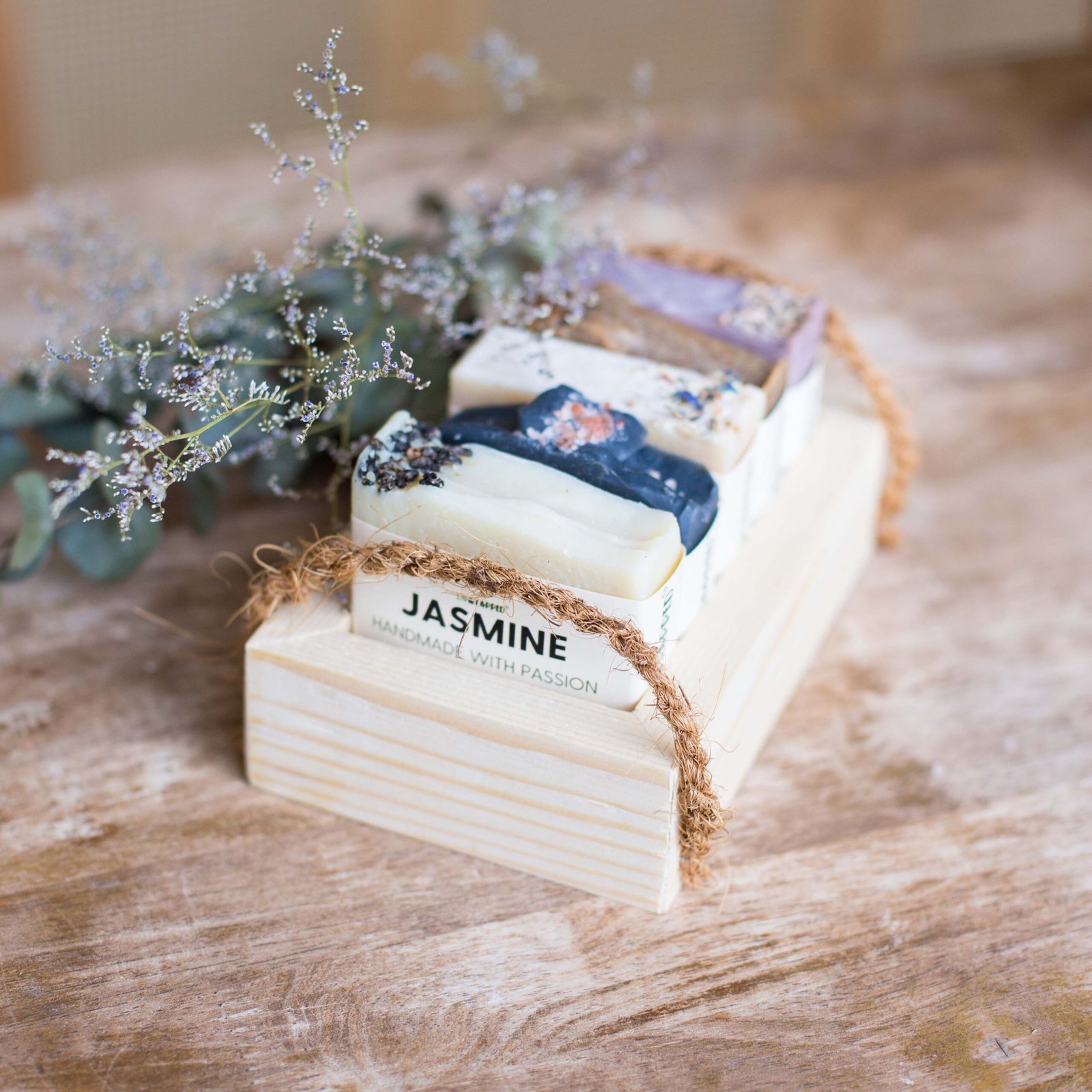 Unwrapped three soap bars in wooden crate