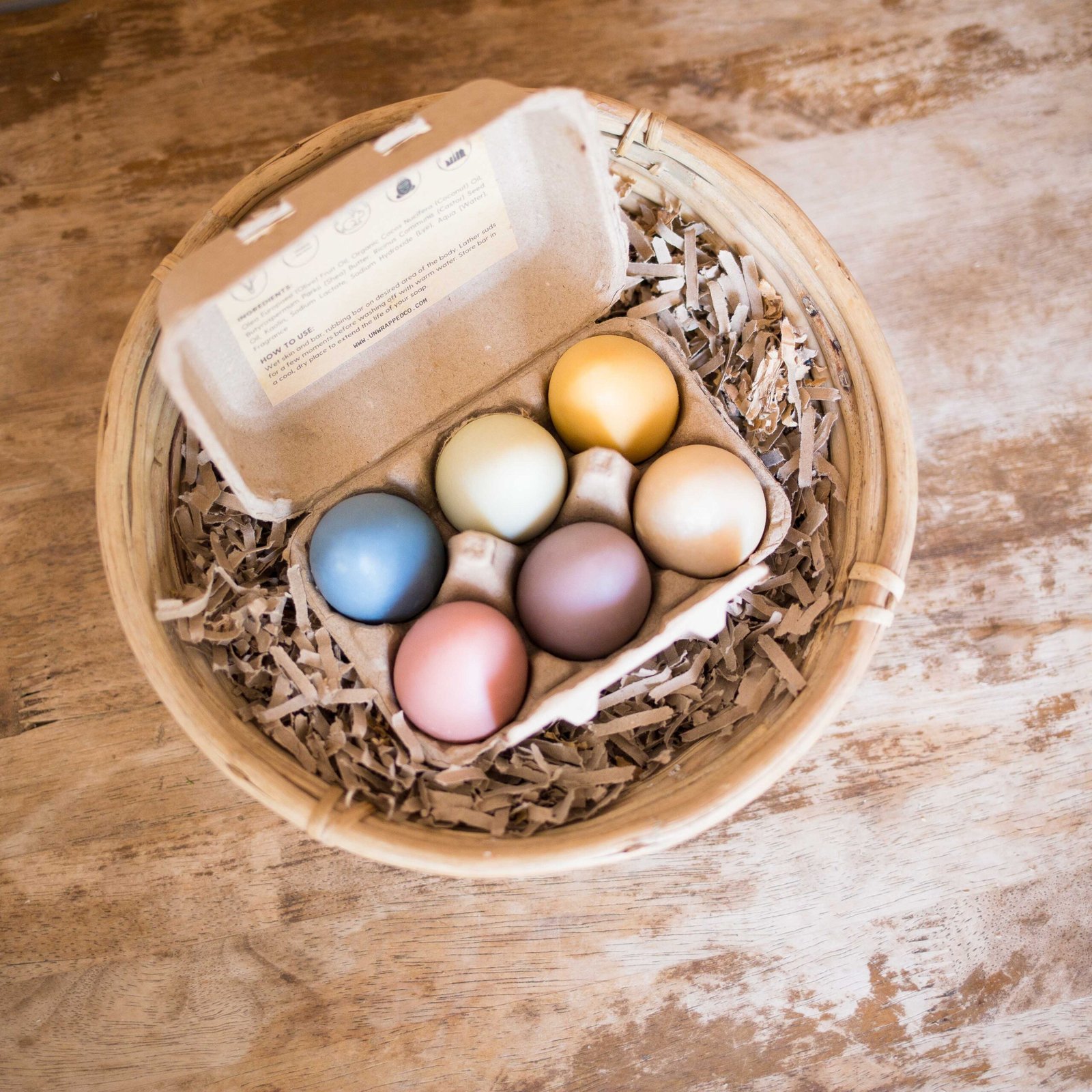 Unwrapped set of six egg shaped soaps in paper egg carton