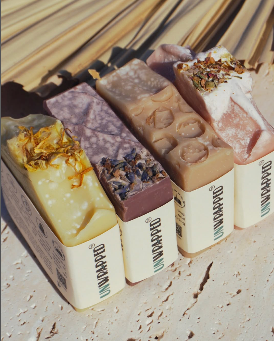 Lifestyle image of three Unwrapped soap bars