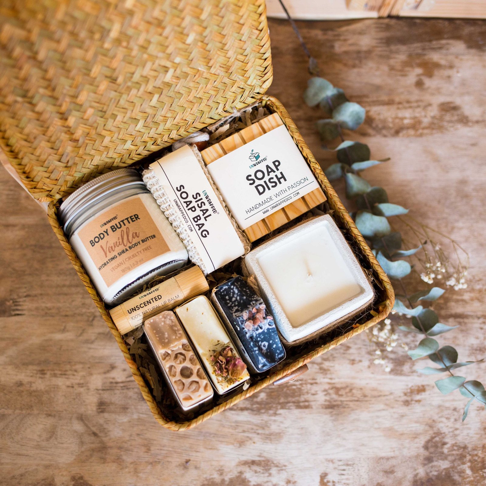 Unwrapped self care gift set with whipped body butter, sisal soap bag, soap dish, lip balm, small candle and three soap bars
